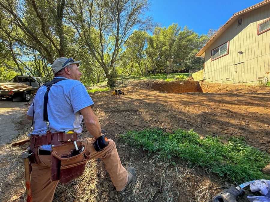 Chip kneeling at a dig